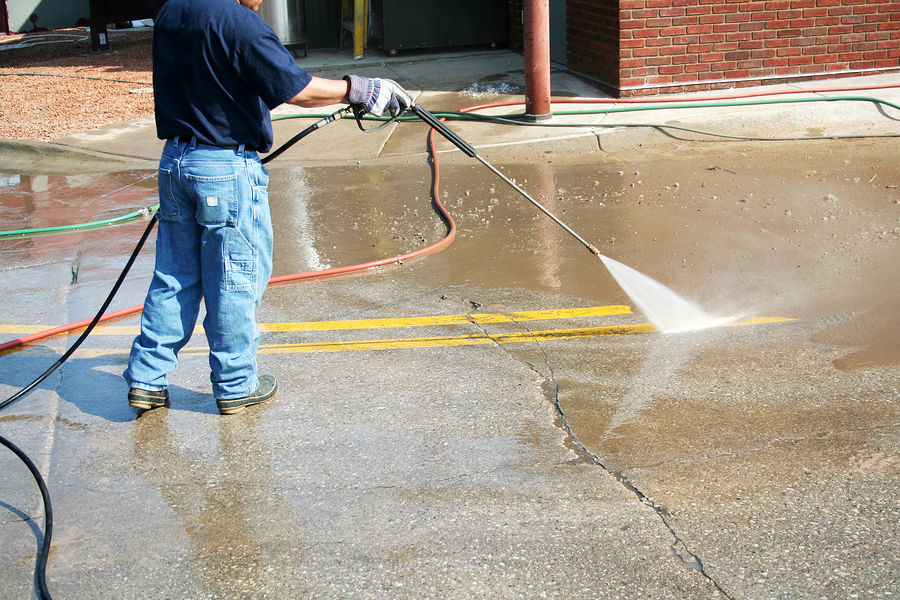 Crew Member Cleans The Painted Street Markings